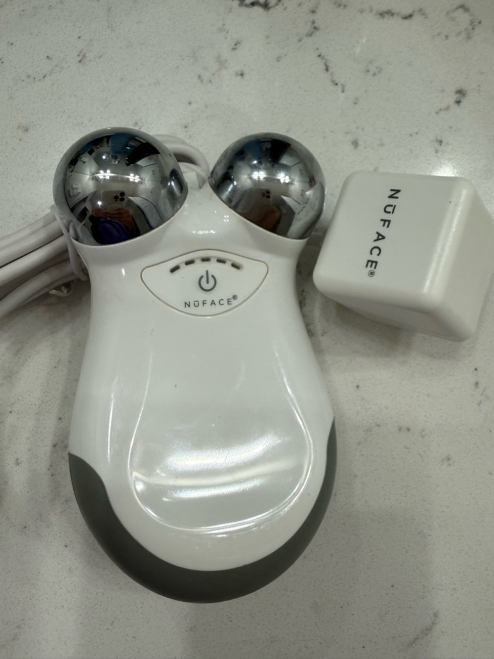 NuFace Mini Handheld Microcurrent Facial Sculpting Device in White and Silver